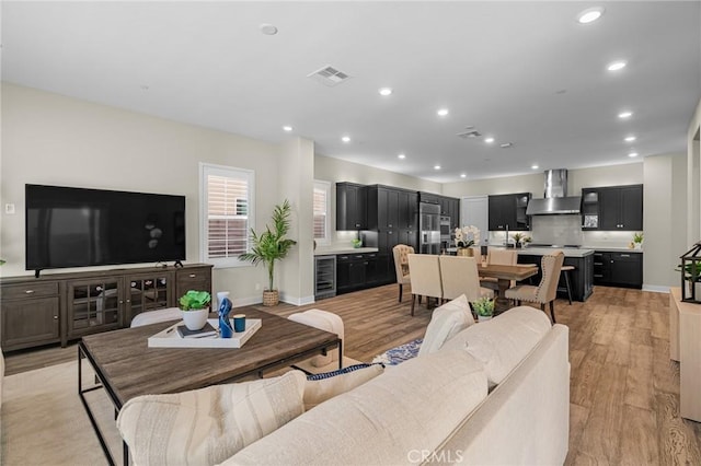 62 Pelican Ln, Irvine, CA 92618 - living room featuring wine cooler, recessed lighting, light wood finished floors, and baseboards
