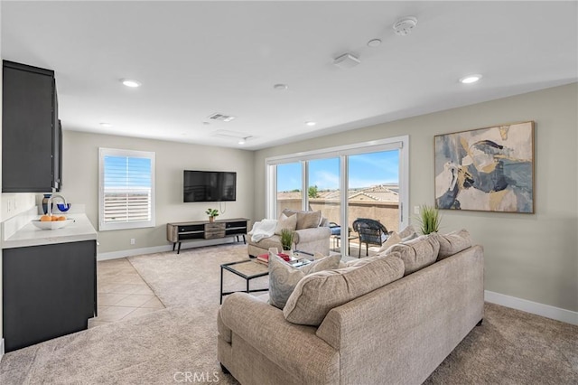 62 Pelican Ln, Irvine, CA 92618 - living area with light carpet, baseboards, healthy amount of natural light, recessed lighting, and light tile patterned flooring