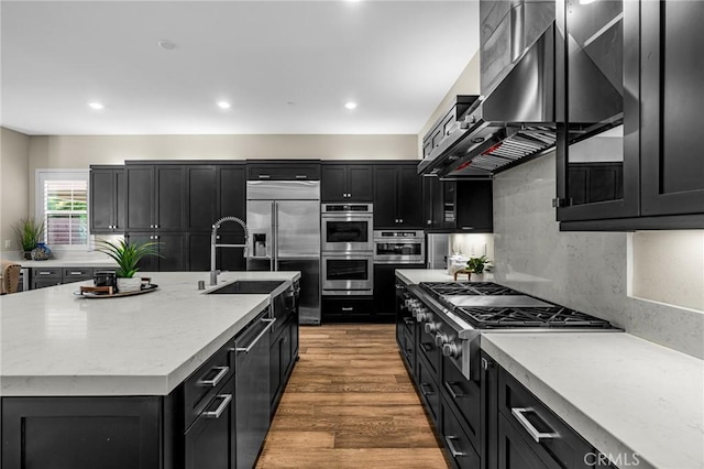 62 Pelican Ln, Irvine, CA 92618 - kitchen with dark cabinets, appliances with stainless steel finishes, light wood finished floors, a sink, and recessed lighting