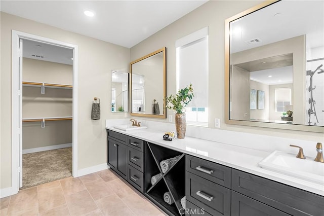 62 Pelican Ln, Irvine, CA 92618 - bathroom with double vanity, baseboards, a walk in closet, and a shower