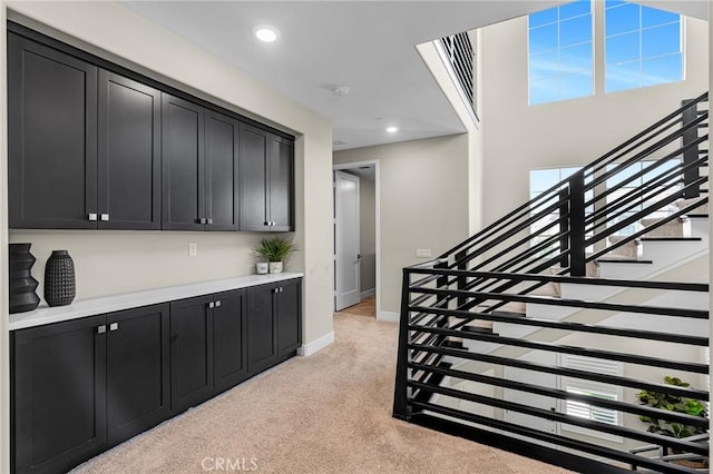 62 Pelican Ln, Irvine, CA 92618 - interior space featuring dark cabinetry, light colored carpet, recessed lighting, baseboards, and light countertops