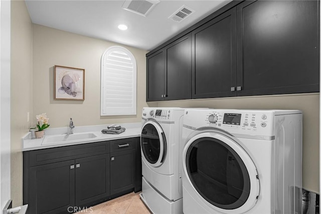 62 Pelican Ln, Irvine, CA 92618 - laundry area with independent washer and dryer, cabinet space, light tile patterned flooring, and recessed lighting