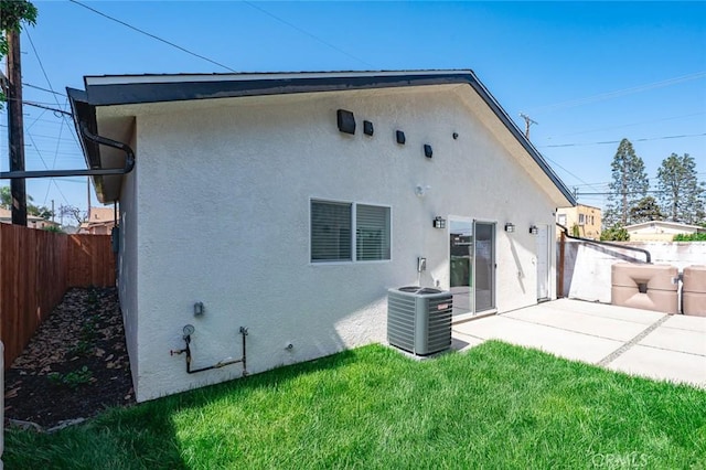 939 E 97th St, Los Angeles, CA 90002 - rear view of property featuring central AC, stucco siding, and a patio
