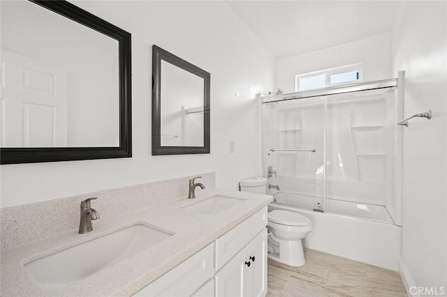 939 E 97th St, Los Angeles, CA 90002 - bathroom featuring toilet, double vanity, and bath / shower combo with glass door