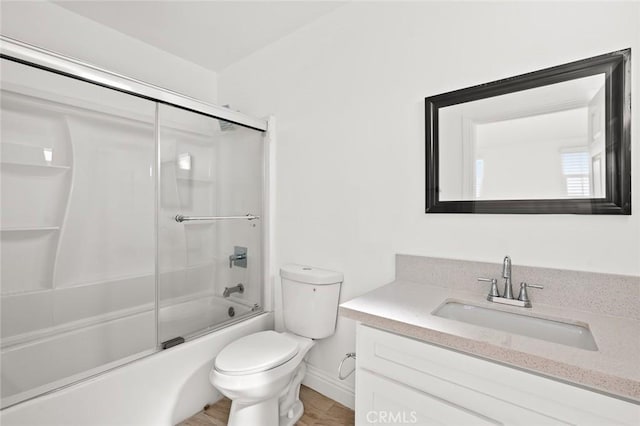 939 E 97th St, Los Angeles, CA 90002 - bathroom featuring vanity, toilet, shower / bath combination with glass door, and wood finished floors