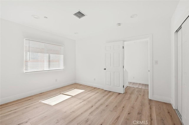 939 E 97th St, Los Angeles, CA 90002 - unfurnished bedroom featuring light wood finished floors, baseboards, and a closet