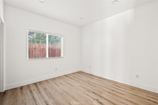 939 E 97th St, Los Angeles, CA 90002 - unfurnished room with wood finished floors, baseboards, and recessed lighting