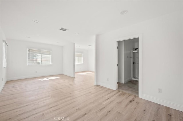 939 E 97th St, Los Angeles, CA 90002 - unfurnished living room with light wood-style flooring, baseboards, and recessed lighting
