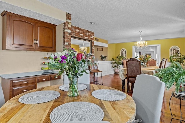 11180 Bertrand Ave, Granada Hills, CA 91344 - dining area with a chandelier, wood finished floors, and a textured ceiling