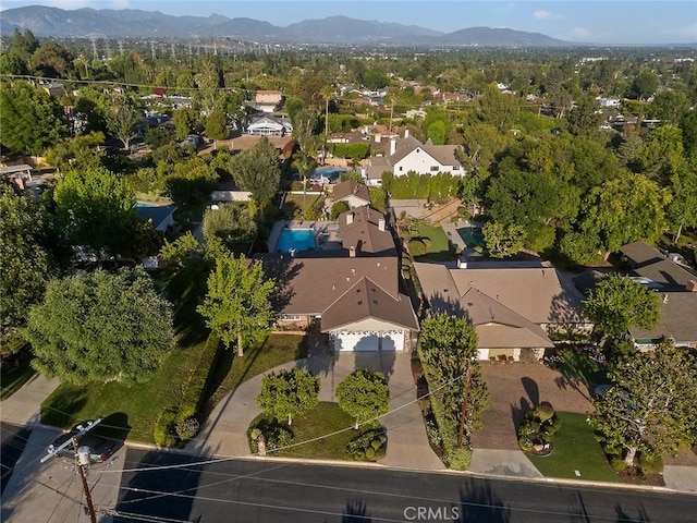 11180 Bertrand Ave, Granada Hills, CA 91344 - aerial view of property and surrounding area featuring a mountainous background and nearby suburban area