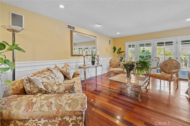 11180 Bertrand Ave, Granada Hills, CA 91344 - living room with a textured ceiling, wood finished floors, wainscoting, recessed lighting, and french doors