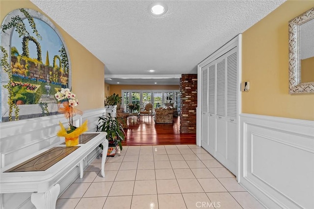 11180 Bertrand Ave, Granada Hills, CA 91344 - hallway featuring a textured ceiling, a wainscoted wall, light tile patterned flooring, and recessed lighting