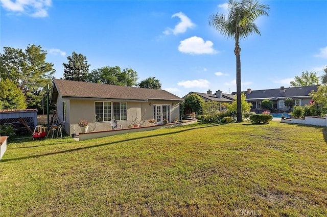 11180 Bertrand Ave, Granada Hills, CA 91344 - view of front of home with french doors, a front lawn, and stucco siding
