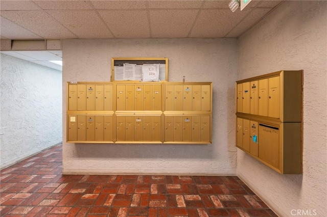 1375 Kelton Ave Unit 104, Los Angeles, CA 90024 - view of home's community with mail area, a textured wall, and a drop ceiling