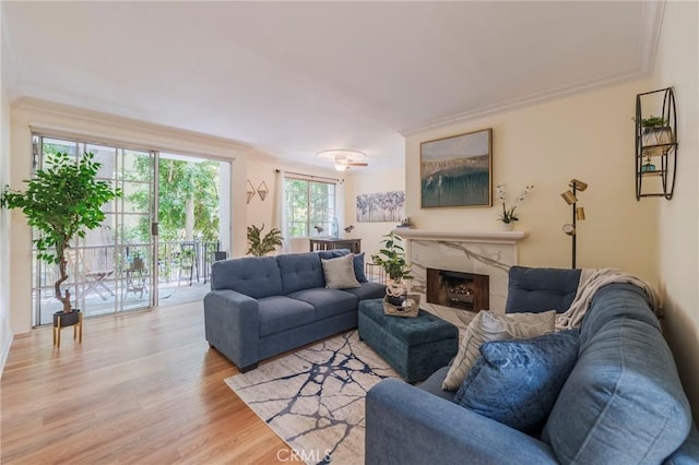 1375 Kelton Ave Unit 104, Los Angeles, CA 90024 - living room featuring crown molding, light wood-style floors, and a high end fireplace