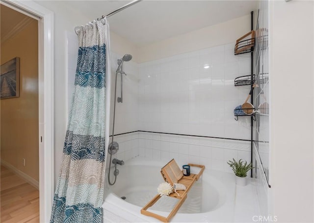 1375 Kelton Ave Unit 104, Los Angeles, CA 90024 - full bathroom with shower / bathtub combination with curtain, wood finished floors, and baseboards