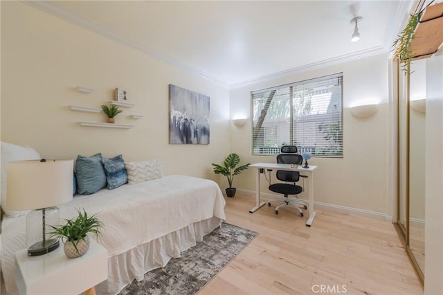 1375 Kelton Ave Unit 104, Los Angeles, CA 90024 - bedroom featuring ornamental molding, baseboards, a desk, and wood finished floors