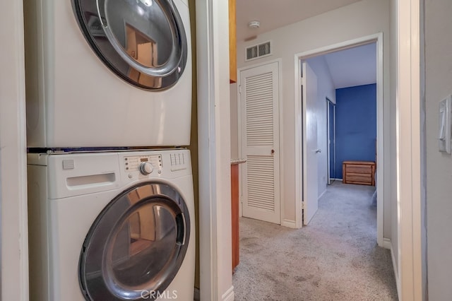1775 Freeman Ave Unit 304, Long Beach, CA 90804 - laundry area with estacked washer and dryer, carpet floors, and baseboards
