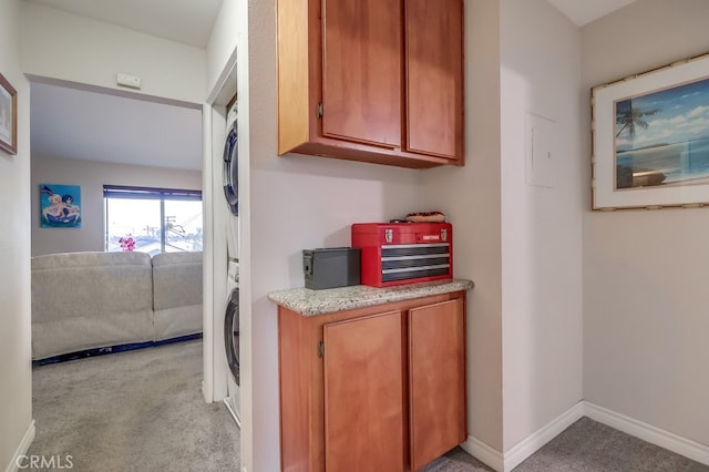 1775 Freeman Ave Unit 304, Long Beach, CA 90804 - washroom with stacked washer / drying machine and light carpet