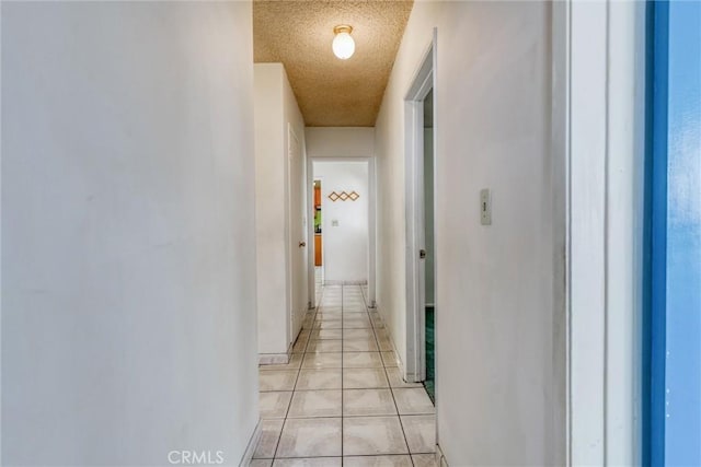 17415 Minnehaha St, Granada Hills, CA 91344 - hallway with light tile patterned floors, a textured ceiling, and baseboards