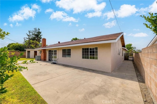 17415 Minnehaha St, Granada Hills, CA 91344 - back of property with stucco siding, a chimney, and a patio