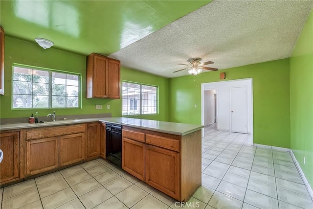 17415 Minnehaha St, Granada Hills, CA 91344 - kitchen featuring black dishwasher, a sink, a peninsula, brown cabinets, and light countertops