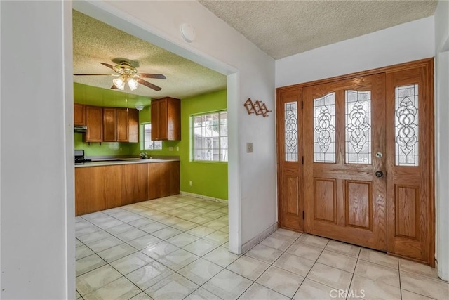 17415 Minnehaha St, Granada Hills, CA 91344 - entryway with a textured ceiling, a ceiling fan, light tile patterned floors, and baseboards