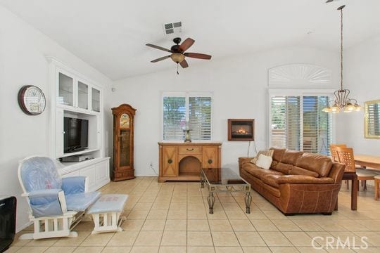 4516 Streamport Dr, Riverside, CA 92505 - living area featuring vaulted ceiling, plenty of natural light, light tile patterned floors, ceiling fan, and a chandelier