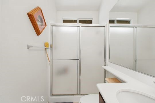 4516 Streamport Dr, Riverside, CA 92505 - bathroom with vanity, toilet, and a shower stall
