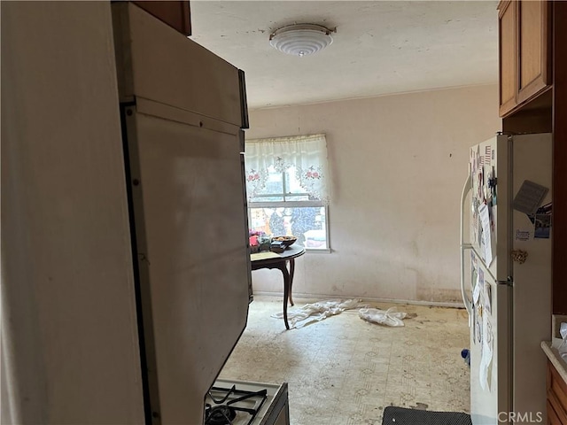 4058 Bledsoe Ave, Culver City, CA 90066 - kitchen with freestanding refrigerator, brown cabinets, and light countertops
