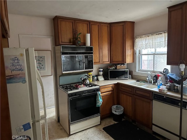 4058 Bledsoe Ave, Culver City, CA 90066 - kitchen featuring white appliances, light countertops, brown cabinets, a sink, and light flooring