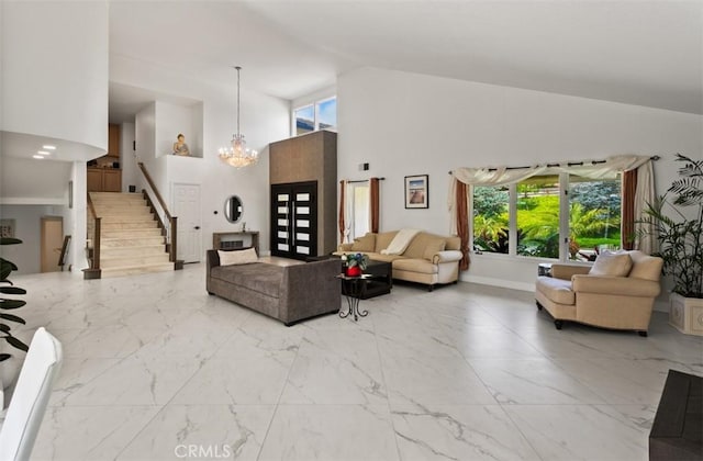 27773 Hidden Trail Rd, Laguna Hills, CA 92653 - living room with a chandelier, stairs, high vaulted ceiling, marble finish floors, and baseboards