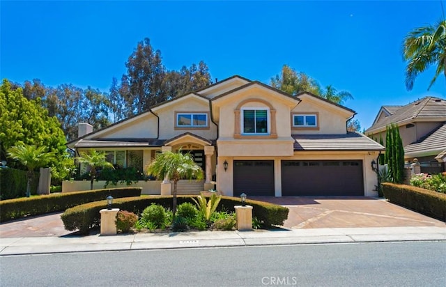 27773 Hidden Trail Rd, Laguna Hills, CA 92653 - traditional-style home with an attached garage, driveway, and stucco siding