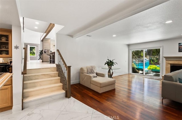 27773 Hidden Trail Rd, Laguna Hills, CA 92653 - living room featuring stairs, recessed lighting, a fireplace, baseboards, and light marble finish flooring