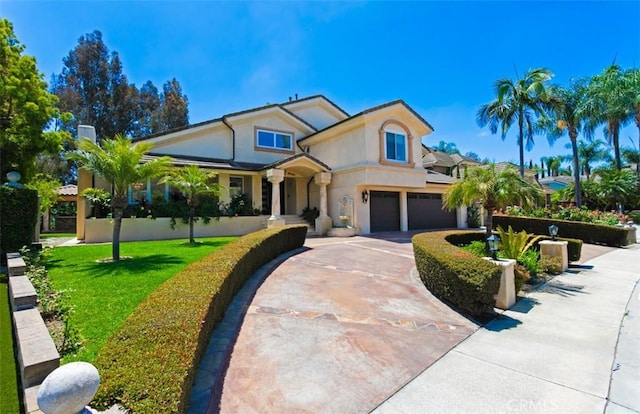 27773 Hidden Trail Rd, Laguna Hills, CA 92653 - view of front of home featuring a garage, stucco siding, concrete driveway, and a front yard