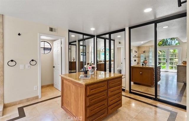 27773 Hidden Trail Rd, Laguna Hills, CA 92653 - bathroom featuring inlaid floor details, french doors, baseboards, recessed lighting, and vanity