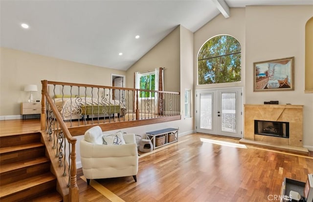 27773 Hidden Trail Rd, Laguna Hills, CA 92653 - living room with high vaulted ceiling, wood finished floors, beam ceiling, french doors, and a high end fireplace