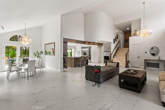 27773 Hidden Trail Rd, Laguna Hills, CA 92653 - living area featuring a chandelier, light marble finish floors, stairway, and high vaulted ceiling