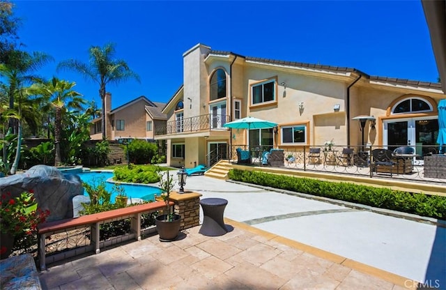 27773 Hidden Trail Rd, Laguna Hills, CA 92653 - back of property with a balcony, stucco siding, a patio, and french doors