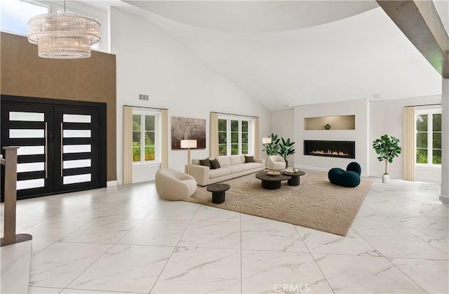 27773 Hidden Trail Rd, Laguna Hills, CA 92653 - living area with marble finish floors, high vaulted ceiling, a chandelier, built in features, and a warm lit fireplace