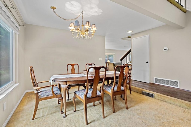 8468 Calle Morelos, San Diego, CA 92126 - dining room featuring a chandelier, light carpet, stairway, and baseboards