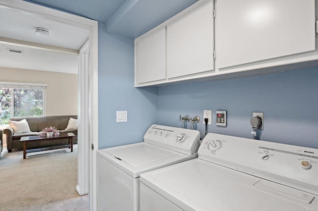 8468 Calle Morelos, San Diego, CA 92126 - laundry area featuring washing machine and clothes dryer, light colored carpet, and cabinet space