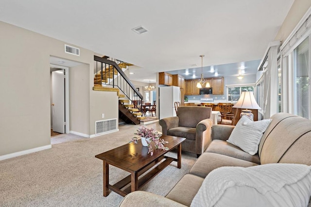 8468 Calle Morelos, San Diego, CA 92126 - living area featuring stairs, baseboards, light colored carpet, and a chandelier