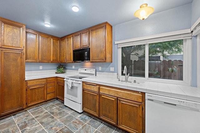 8468 Calle Morelos, San Diego, CA 92126 - kitchen featuring white appliances, brown cabinets, a sink, and tile countertops