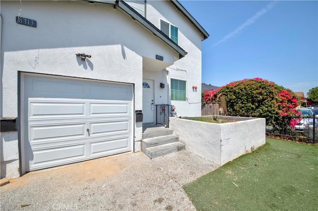 8711 Mckinley Pl, Los Angeles, CA 90002 - view of front of house with stucco siding and a garage