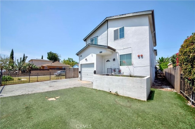 8711 Mckinley Pl, Los Angeles, CA 90002 - rear view of property featuring an attached garage, asphalt driveway, and stucco siding