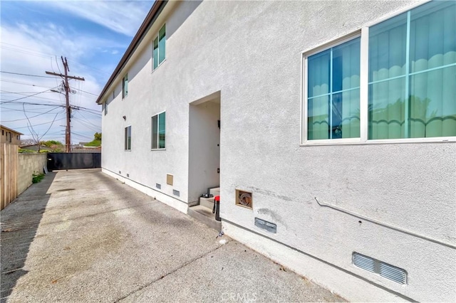 8711 Mckinley Pl, Los Angeles, CA 90002 - view of property exterior featuring stucco siding, a patio, and crawl space