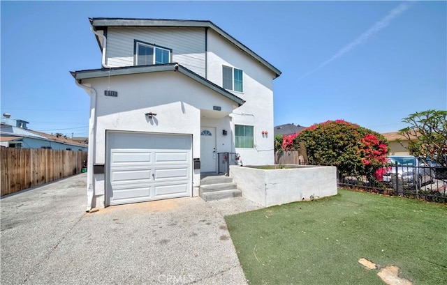 8711 Mckinley Pl, Los Angeles, CA 90002 - view of front of home featuring an attached garage, stucco siding, and driveway