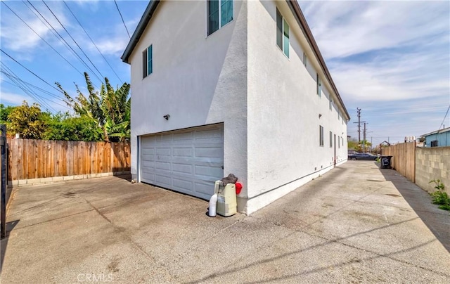 8711 Mckinley Pl, Los Angeles, CA 90002 - view of side of home with a garage and stucco siding