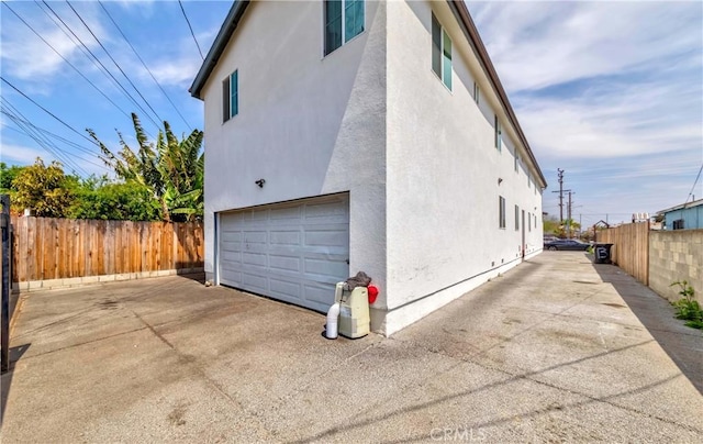 8711 Mckinley Pl, Los Angeles, CA 90002 - view of property exterior featuring a garage and stucco siding